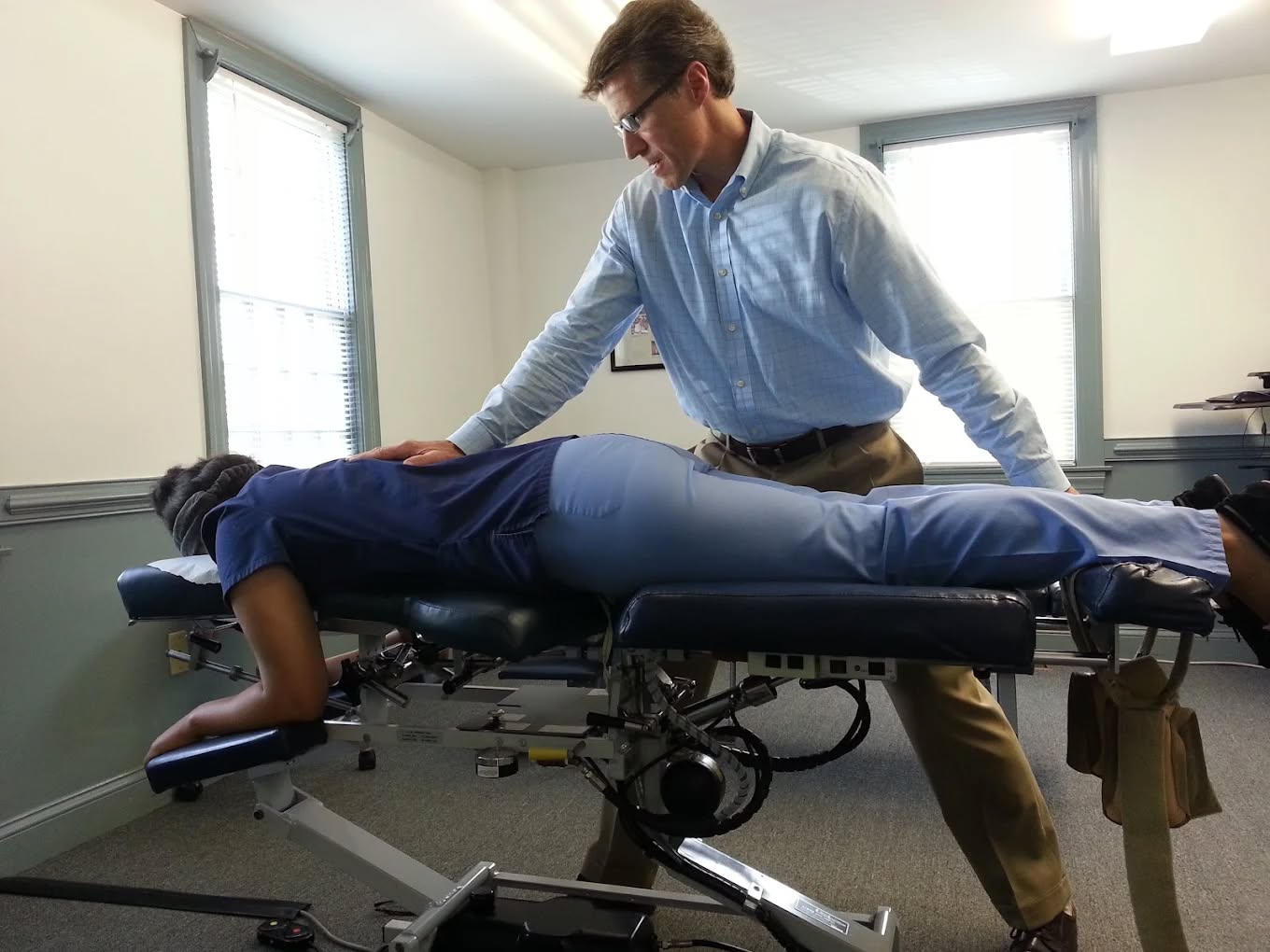 Patient receiving flexion-distraction treatment for acute low back pain